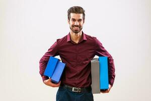 A man in a purple shirt holding boxes photo