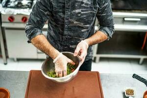 A chef is preparing a meal in the restaurant's kitchen. photo