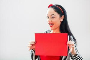 un mujer participación un rojo papel foto