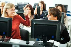 Students learning in a computer lab photo