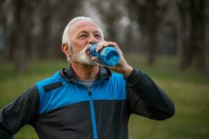 A senior man doing physical exercises photo