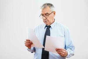 Portrait of a serious senior businessman with papers photo