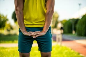 A man in a yellow t-shirt doing physical exercises photo