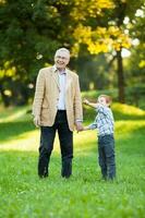 A grandfather and his grandson spending time together outdoors photo