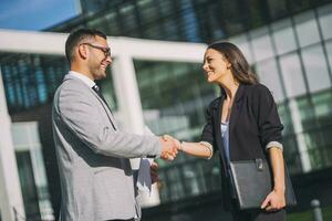 Business colleagues are talking outside the company building. photo