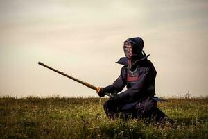 Silhouette of kendo fighter with shinai photo