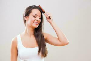 A woman taking care of her hair photo