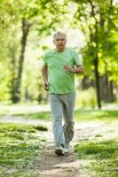 A senior man doing physical exercises photo