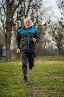 A senior man doing physical exercises photo