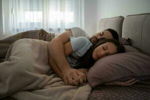 A young couple lying in bed photo