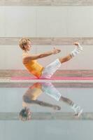 A woman doing physical exercises at the swimming pool photo