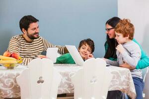 Parents are teaching their children to use the laptop photo