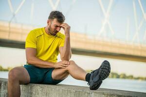 A man in a yellow t-shirt doing physical exercises photo