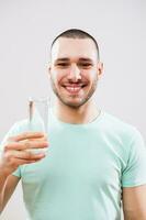 A man with green tshirt drinking water photo