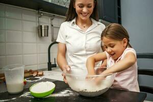 Mother and daughter cooking together photo