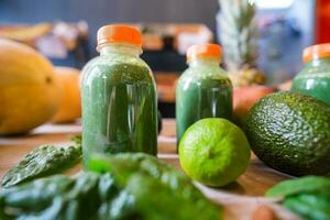 Healthy protein shake on table with fruits and vegetables ingredients around photo