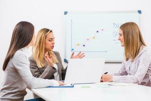 Businesswomen discussing business plan photo