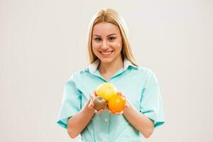 A nurse holding fruits in her hand photo