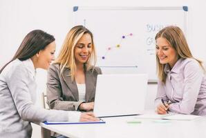 Businesswomen discussing business plan photo