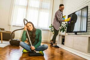 Young couple is cleaning their apartment photo