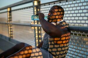 An African American man drinking water photo