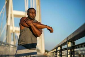 An African American man doing physical exercises photo