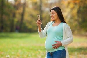 A pregnant woman spending time outdoors photo