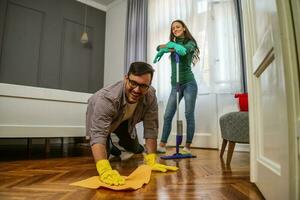 Young couple is cleaning their apartment photo