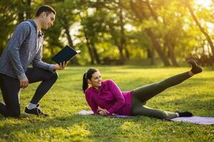 Couple exercising together in the park photo