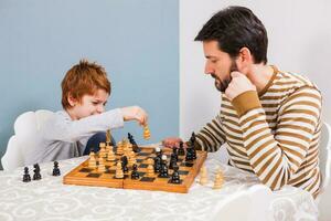 A man playing chess with a child photo