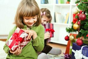 Young girs opening Christmas presents photo