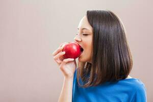 un mujer comiendo un manzana foto