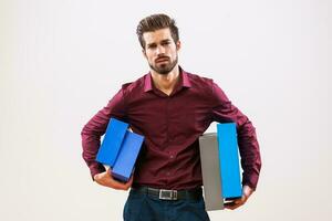 A man in a purple shirt holding boxes photo