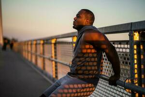 An African American man doing physical exercises photo