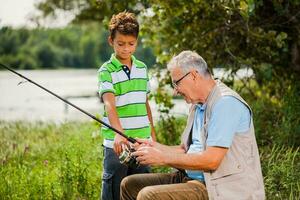 A grandfather and his nephew fishing photo