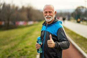 A senior man doing physical exercises photo