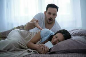 A young couple lying in bed photo