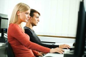 Students learning in a computer lab photo