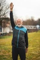 A senior man doing physical exercises photo