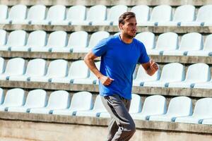 Young man running outdoors photo