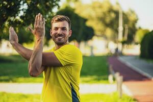 A man in a yellow t-shirt doing physical exercises photo