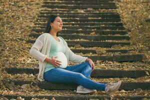 A pregnant woman spending time outdoors photo