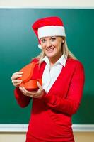 A woman opening her Christmas gift photo