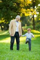 A grandfather and his grandson spending time together outdoors photo