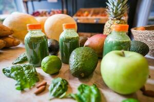 Healthy protein shake on table with fruits and vegetables ingredients around photo