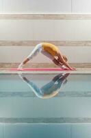 A woman doing physical exercises at the swimming pool photo