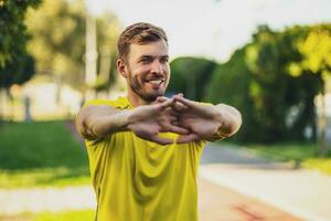 A man in a yellow t-shirt doing physical exercises photo