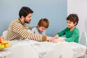 A father helping his kids with the homework photo