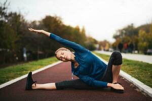 A young woman doing physical exercises photo