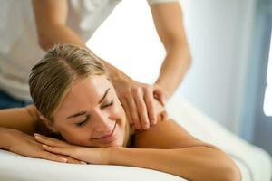 Woman enjoying a back massage photo